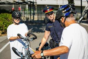 Bezirksinspektorin Marion Seidl im Gespräch mit einer Radfahrerin und einem Radfahrer.
